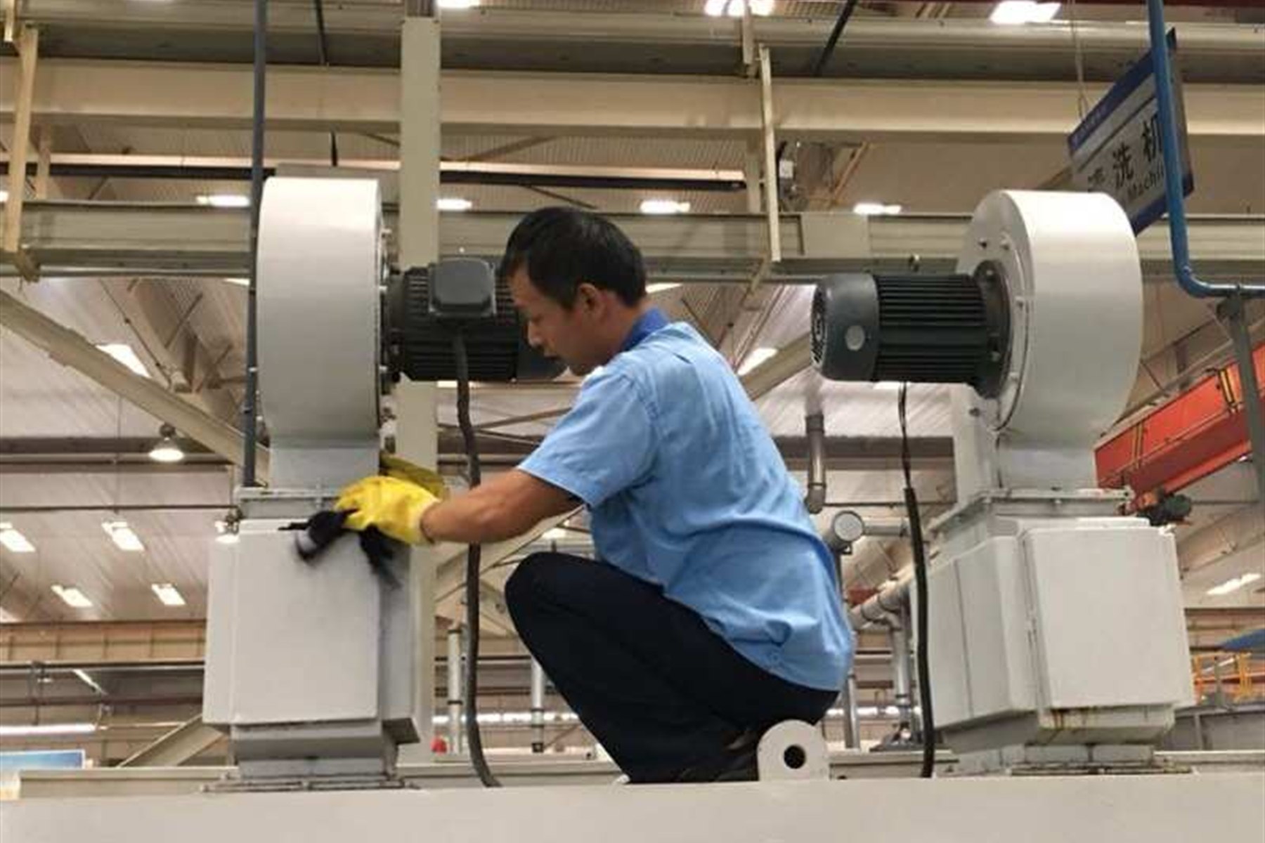 A technician inspecting industrial testing equipment